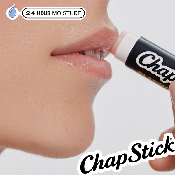 ChapStick lip balm applied to lips with white-capped tube near mouth