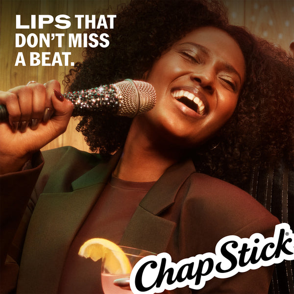 ChapStick logo overlay on smiling model with singer microphone in frame.